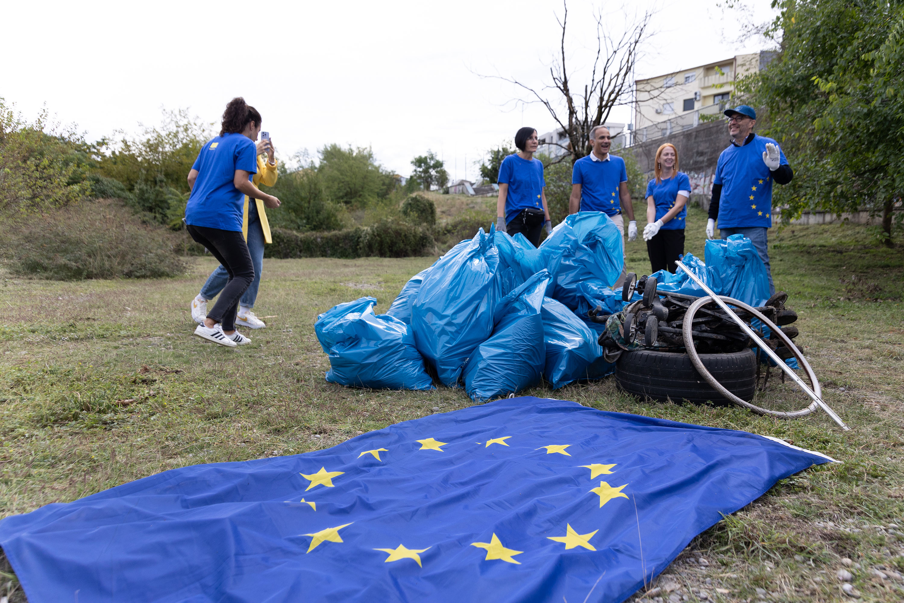 2024 EUBeachCleanup in Montenegro, 5 people, plastic bags filled with rubbish and an EU flag in the foreground