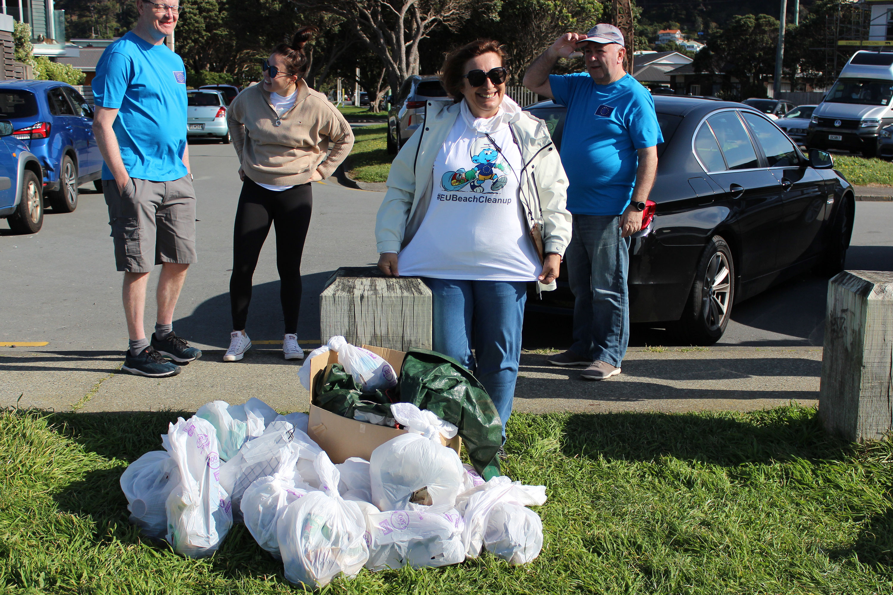 2024 EUBeachCleanup in New Zealand, 4 people and white plastic bags filled with rubbish
