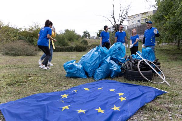 2024 EUBeachCleanup in Montenegro, 5 people, plastic bags filled with rubbish and an EU flag in the foreground